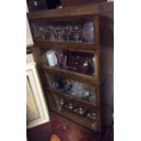 AN EARLY 20TH CENTURY OAK GLOBE WERNICKE CABINET Having a canister of four glazed compartments. (