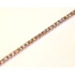 AN 18CT WHITE GOLD AND DIAMOND TENNIS BRACELET Set with approximately 90 round cut diamonds. (length