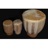 A SET OF THREE 20TH CENTURY AFRICAN COW SKIN DRUMS One large and two small, with rope decoration. (