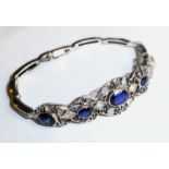 A VINTAGE WHITE METAL, SAPPHIRE AND DIAMOND BRACELET The arrangement of oval cut sapphires held in a