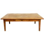 A 19TH CENTURY FRENCH FRUITWOOD COFFEE TABLE The plank top above a single drawer, raised on square