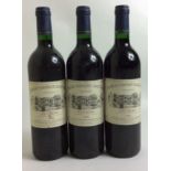 THREE BOTTLES OF VINTAGE WINE Château Constant Lesquireau, 1995, Haute-Médoc, bearing total blue