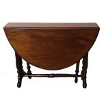 A VICTORIAN MAHOGANY SUTHERLAND TABLE With turned stretcher and legs standing on brass castors. (