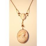 A 9CT GOLD CAMEO PENDANT With two cameos suspended from a fine 9ct gold chain.