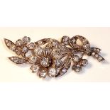 A YELLOW AND DIAMOND ANTIQUE BROOCH Modelled as a flower set with approximately 45 round cut