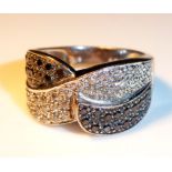 AN 18CT GOLD BLACK AND WHITE DIAMOND RING Set with approximately 20 black round cut diamonds and