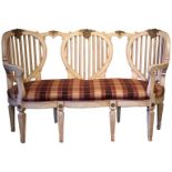 AN EARLY 20TH CENTURY FRENCH STYLE PAINTED LOVESEAT With checker upholstery and scrolling arms,