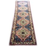 A PERSIAN HAMEDAN RUNNER RUG Having a pink and blue ground central field with large floral