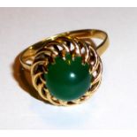 A VINTAGE 14CT GOLD AND JADE RING Having a single cabochon cut jade stone set in a spiral shape