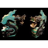 A PAIR OF CHINESE MING POTTERY ROOF TILES Cast as fierce dragons in a green and black. (approx 53cm)