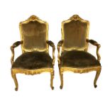 A PAIR OF 18TH/19TH CENTURY CARVED GILTWOOD OPEN ARMCHAIRS The shaped backs carved with central