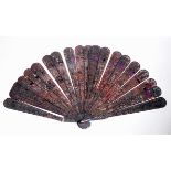 A 19TH CENTURY TORTOISE SHELL FAN With pierced and incised decoration to include figures, dragons,