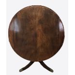 A REGENCY PERIOD MAHOGANY BREAKFAST TABLE The circular top raised on a single pedestal with four