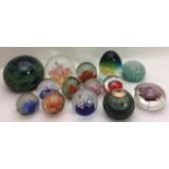 A COLLECTION OF 20TH CENTURY COLOURED GLASS PAPERWEIGHTS Including a blue and green Mdina glass,