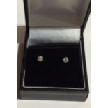 A PAIR OF 9CT GOLD AND DIAMOND STUD EARRINGS Each set with a single round cut diamond.