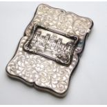 A VICTORIAN 'CASTLE TOP' SCROLLED RECTANGULAR SILVER CARD CASE With an embossed cartouche of the
