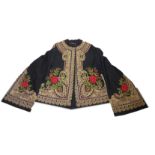 A PERSIAN EMBROIDERED JACKET With foliate and scrolling motifs on a black ground.