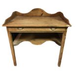 A VICTORIAN PINE WASHSTAND Having a shaped back and single drawer above a shelf. (85cm x 56cm x