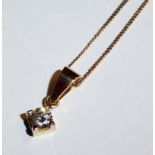 A 9CT GOLD AND DIAMOND PENDANT NECKLACE Having a single round cut diamond held in a square mount,