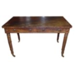 IN THE MANNER OF GILLOW, A MAHOGANY WRITING TABLE With two drawers, raised on tulip and ring