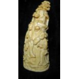 AN ANTIQUE CHINESE IVORY TUSK CARVING Figures in a mountainous landscape. (h 8cm)