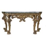 A LARGE EARLY 18TH CENTURY ITALIAN CARVED GILTWOOD SERPENTINE CONSOLE TABLE The faux marble top over