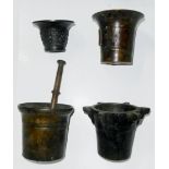 AN ANTIQUE BRONZE PESTLE AND MORTAR Having engraved banding to body, together with three bronze