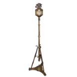 A 19TH CENTURY BRASS STANDARD OIL LAMP Raised on a tripod base. (h 142cm)