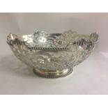 JOSEPH ROUND, AN EARLY 20TH CENTURY SILVER BOWL With pierced floral motifs raised on a gadrooned