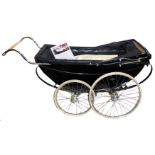AN EARLY 20TH CENTURY BLACK MILLSON'S PRAM The black coach built body trimmed in red, raised on