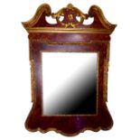 A 20TH CENTURY GEORGIAN STYLE FAUX WALNUT AND GILT MIRROR Having a broken pediment and edged with