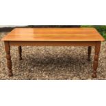 A 20TH CENTURY AUSTRALIAN PINE FARMHOUSE TABLE Raised on turned legs.