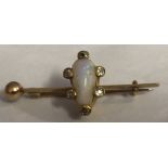 AN ANTIQUE YELLOW METAL, OPAL AND DIAMOND BAR BROOCH Set with a pair of shaped opals surrounded by