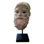 AFTER THE ANTIQUE, A BRONZE BUST OF A GREEK GOD Wearing a helmet and elongated beard. (approx 14cm x