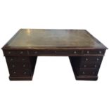 A 19TH CENTURY MAHOGANY TWIN PEDESTAL DESK With green tooled leather writing surface above nine