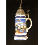 AN IMPERIAL GERMAN CHINA BEER STEIN Decorated with a narrative scene. (30cm)