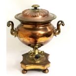 AN EARLY 19TH CENTURY COPPER AND BRASS SAMOVAR Classical shape with twin handles, raised on bun