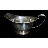 AN EARLY 20TH CENTURY SILVER SAUCE BOAT Having a geometric Art Deco style handle, hallmarked