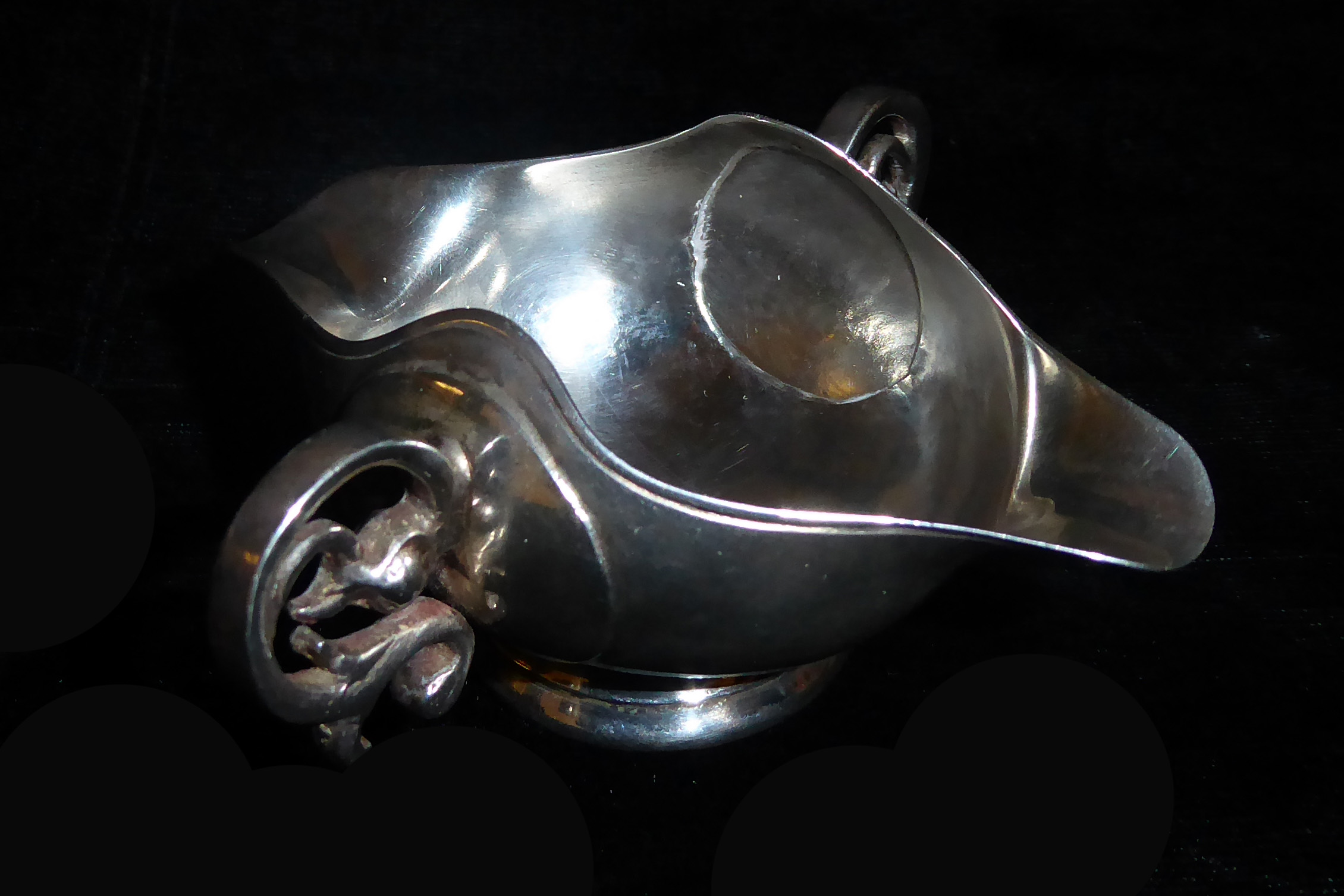 A 20TH CENTURY SILVER SAUCE BOAT With coin inset to base, flanked by scrolling handles. (h 4.5cm)