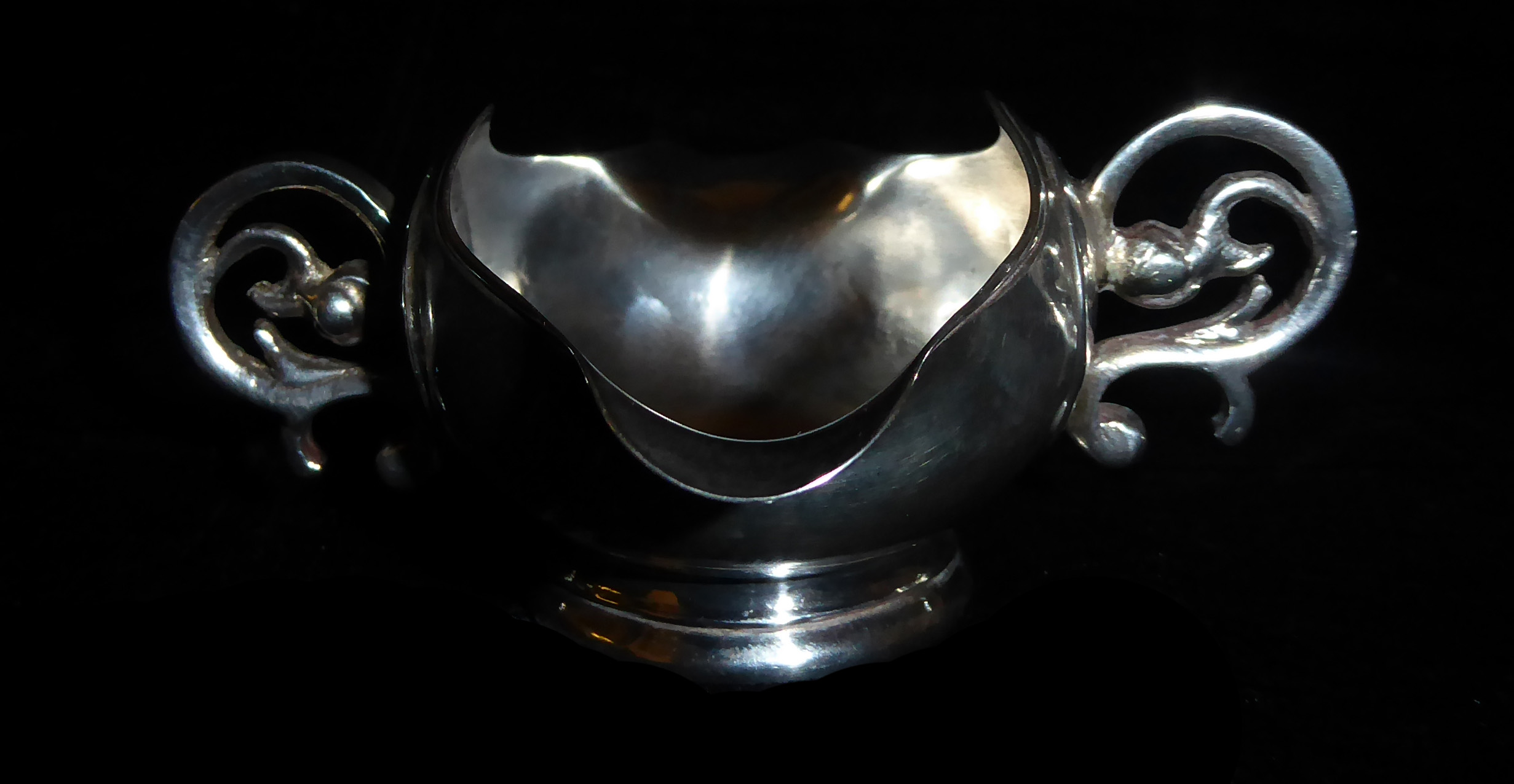 A 20TH CENTURY SILVER SAUCE BOAT With coin inset to base, flanked by scrolling handles. (h 4.5cm) - Image 2 of 4