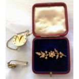 A VICTORIAN 15CT GOLD AND SEED PEARL BROOCH The arrangement of pearls forming a floral spray, held