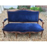 A LATE 19TH/EARLY 20TH CENTURY FRENCH WALNUT FRAMED SETTEE Carved with cartouches and florets, in