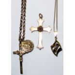 A COLLECTION OF VINTAGE 9CT GOLD PENDANTS Two crucifixes, one set with a single ruby and seed