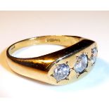 AN 18CT GOLD AND DIAMOND THREE STONE RING With three graduated round cut diamonds (size S).