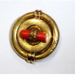 A VICTORIAN YELLOW METAL AND CORAL ETRUSCAN STYLE CIRCULAR BROOCH With scrolled decoration set