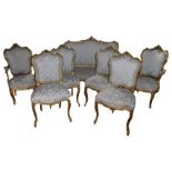 A 19TH CENTURY LOUIS XV STYLE CARVED GILTWOOD SEVEN PIECE SALON SUITE Comprising a settee and