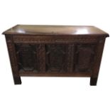 AN 18TH CENTURY OAK THREE PANELLED COFFER With rising hinged lid and candle box cast iron handles,