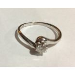 AN 18CT WHITE GOLD AND DIAMOND SOLITAIRE RING Having a single round cut diamond held in a twist