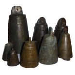 A COLLECTION OF TEN ANTIQUE TIBETAN BRONZE CONICAL BELLS With embossed geometric decoration.