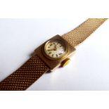 LONGINES, A 9CT GOLD LADIES' WRISTWATCH The circular dial with gilt metal batons, complete with